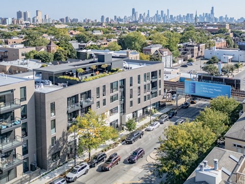 an aerial view of a building with a city in the background